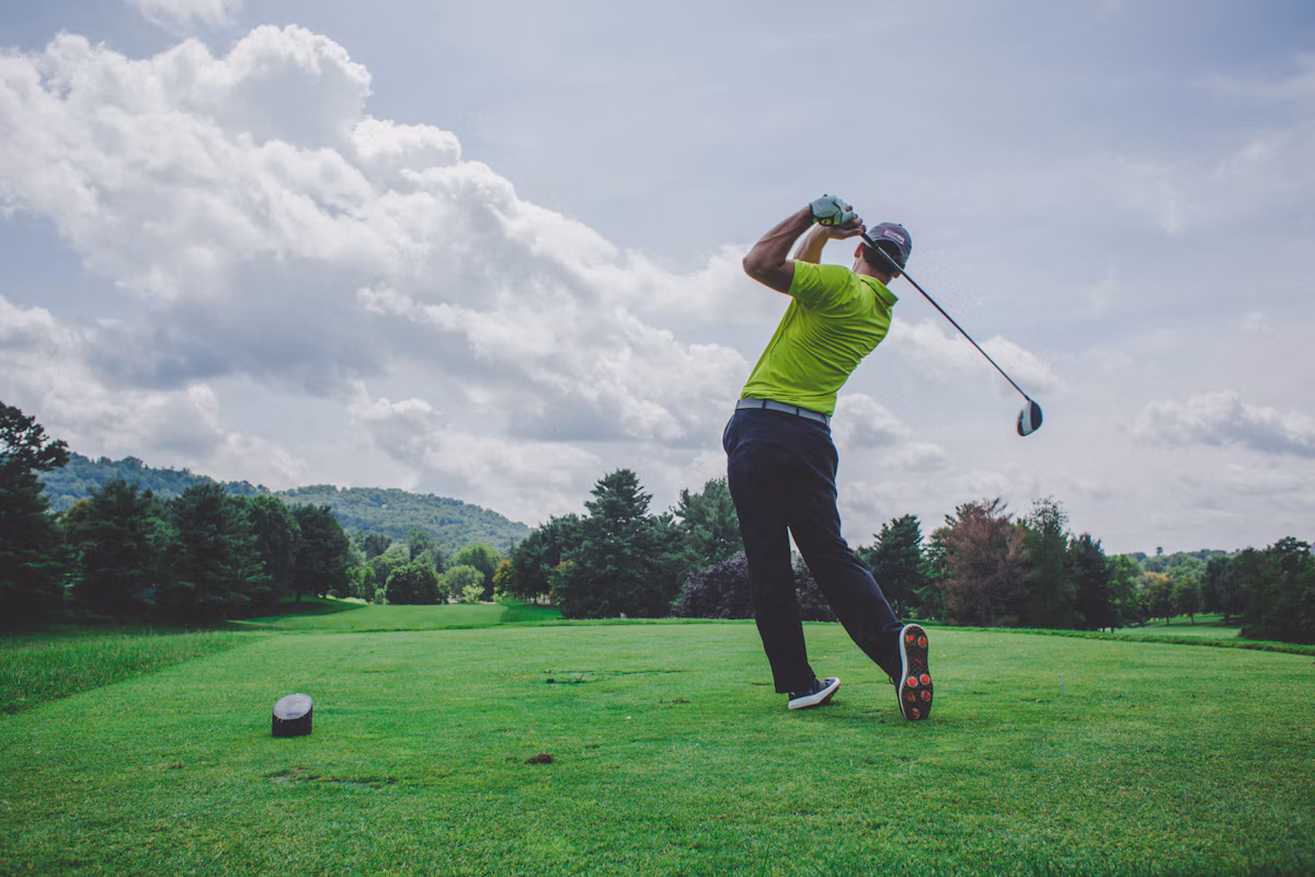 Golfer using mobile phone on golf course
